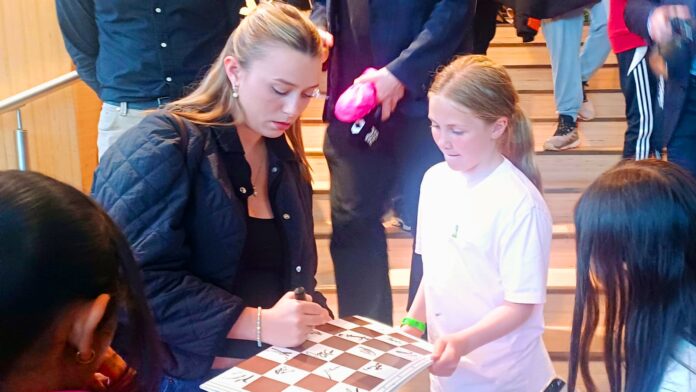 Ella Carlsen, Magnus Carlsen's wife, gives autographs to young fans after the Norway Chess tournament. (Express Photo by Amit Kamath)