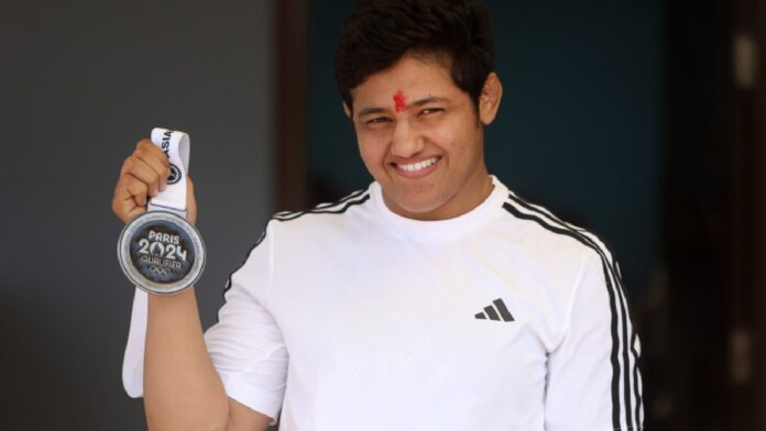 Reetika medal: Wrestler Reetika Hooda poses with the 'Paris Olympics Qualifier' medal at her home in Rohtak. (Credit: Gajendra Yadav)